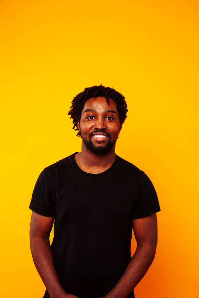 istock young handsome african american guy student posing cheerful and gesturing on yellow background, lifestyle people concept 1367055955