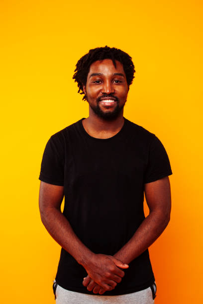 istock young handsome african american guy student posing cheerful and gesturing on yellow background, lifestyle people concept 1367055962