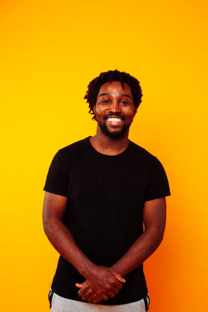 istock young handsome african american guy student posing cheerful and gesturing on yellow background, lifestyle people concept 1367055969