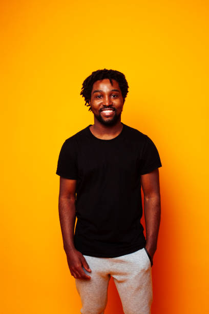 istock young handsome african american guy student posing cheerful and gesturing on yellow background, lifestyle people concept 1367055971
