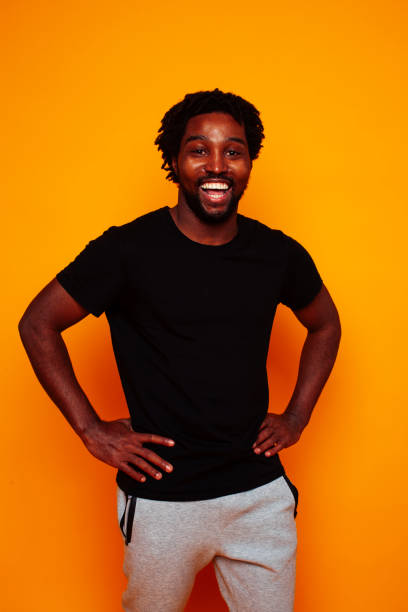istock young handsome african american guy student posing cheerful and gesturing on yellow background, lifestyle people concept 1367055978