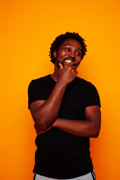istock young handsome african american guy student posing cheerful and gesturing on yellow background, lifestyle people concept 1367056002