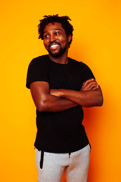istock young handsome african american guy student posing cheerful and gesturing on yellow background, lifestyle people concept 1367056049