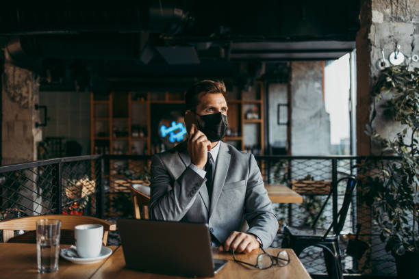 istock Businessman in a restaurant with protective face mask 1367057827
