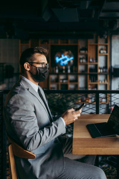 istock Businessman in a restaurant with protective face mask 1367057834