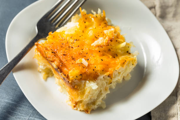 Homemade Cheesy Hashbrown Casserole Homemade Cheesy Hashbrown Casserole with Potatoes and Cream casserole stock pictures, royalty-free photos & images