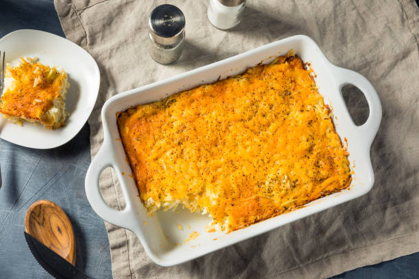 Homemade Cheesy Hashbrown Casserole Homemade Cheesy Hashbrown Casserole with Potatoes and Cream casserole stock pictures, royalty-free photos & images