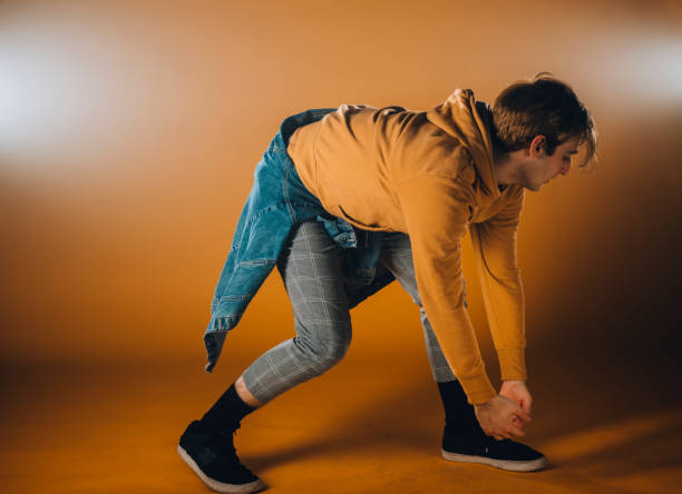 istock Contemporary style dancer on orange wall 1367064233