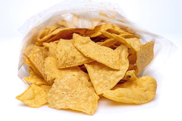 istock Tortilla chips coming out of a cellophane package on white background 1367068933