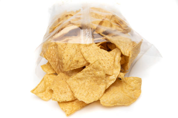 istock Tortilla chips coming out of a cellophane package on white background 1367070804