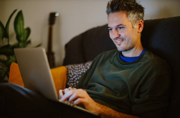 istock mid aged man working on the laptop at home 1367071471