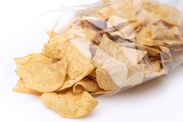 istock Tortilla chips coming out of a cellophane package on white background 1367071496
