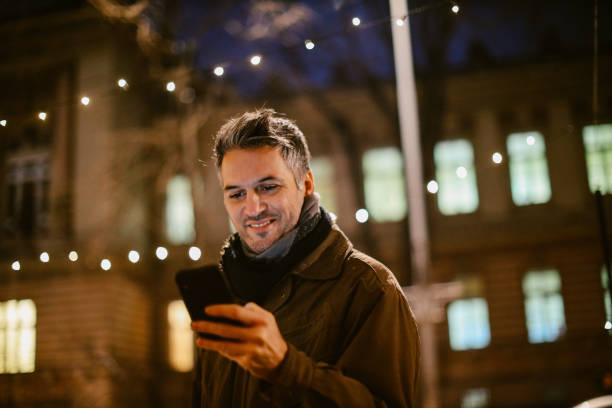istock mid aged man checking his cellphone on the street 1367071526