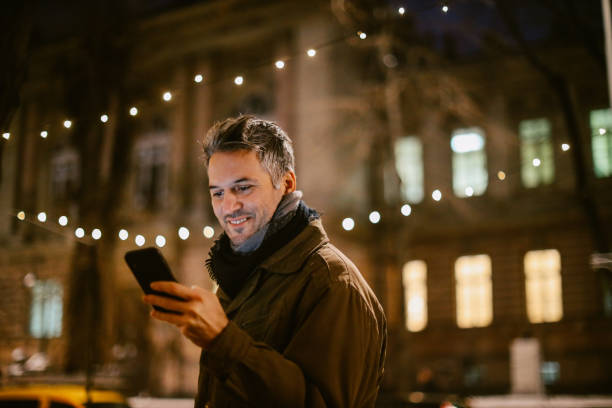 istock mid aged man checking his cellphone on the street 1367071530