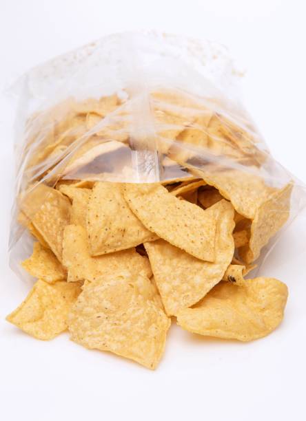 istock Tortilla chips coming out of a cellophane package on white background 1367071666