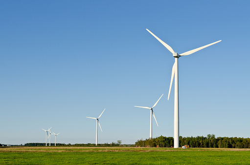 Wind turbine on green grass background