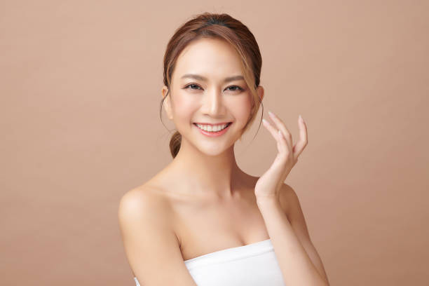 beautiful young asian woman with clean fresh skin on beige background, face care, facial treatment, cosmetology, beauty and spa, asian women portrait. - women smiling body cheerful imagens e fotografias de stock