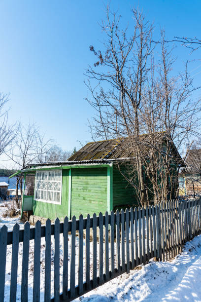 istock Snow around old wooden house. Early spring nature. Selective focus. 1367080183