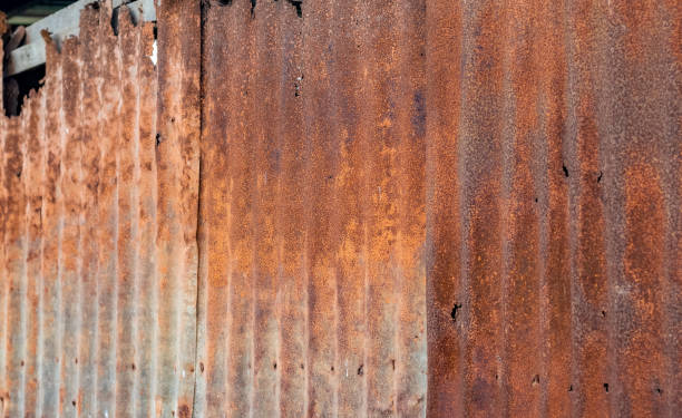 istock Rustic old wavy metal wall on a broken house close up shot with selective focus 1367081002