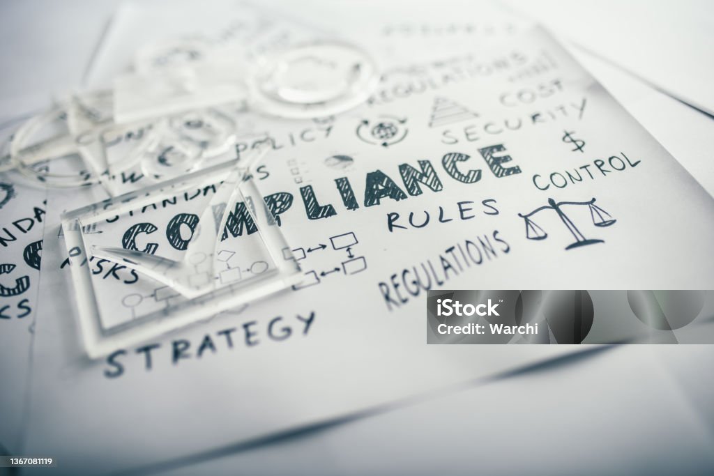 Compliance concept on white papers Transparent check mark over compliance related icons and words handwritten on white papers Obedience Stock Photo
