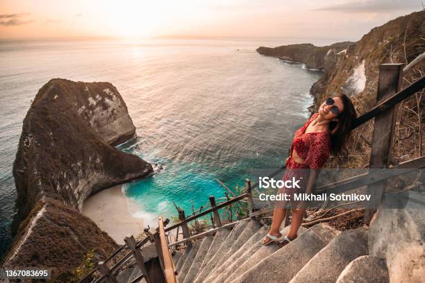 Beautiful Girl On The Background Of Kelingking Beach Nusa Penida Indonesia A Young Woman Is Traveling In Indonesia Nusa Penida Is One Of The Most Famous Tourist Attraction Place To Visit In Bali Stock Photo - Download Image Now