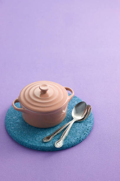 Stainless spoon and cup on pastel background