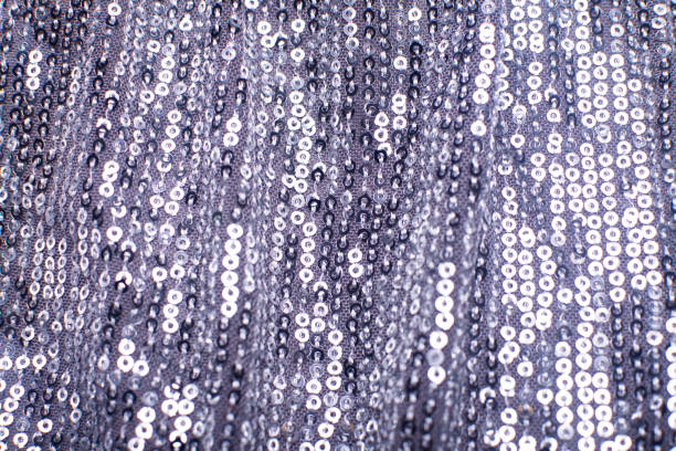 istock Pieces of cloth with silver sequins. Glitter background. Sequin texture 1367095398