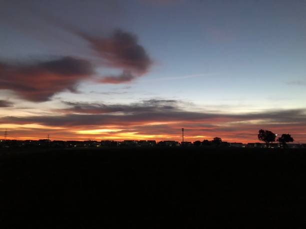 istock Beautiful sunrise with small town silhouette 1367097184