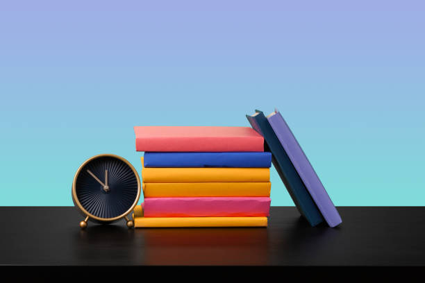 istock Stack of books on black wooden table 1367097321