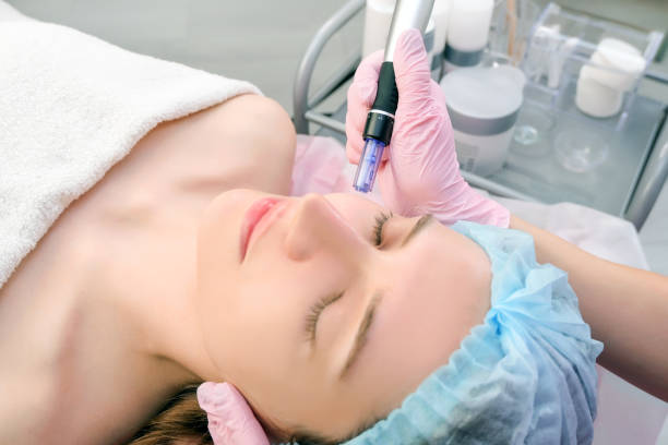 istock Needle mesotherapy. Cosmetologist performs needle mesotherapy on a womans face. 1367098359
