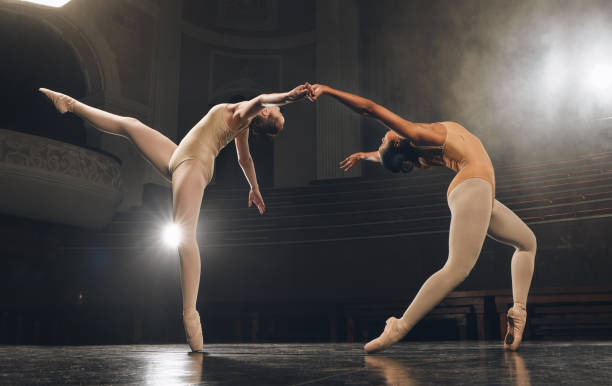 istock Shot of a group of ballet dancers practicing a routine on stage 1367099773