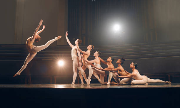 istock Shot of a group of ballet dancers practicing a routine on a stage 1367099783