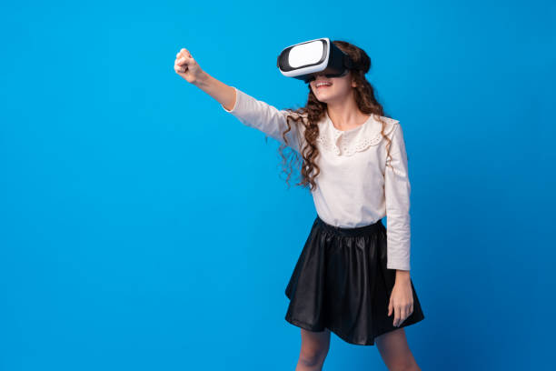 istock Girl with virtual reality glasses on blue background. 1367100666