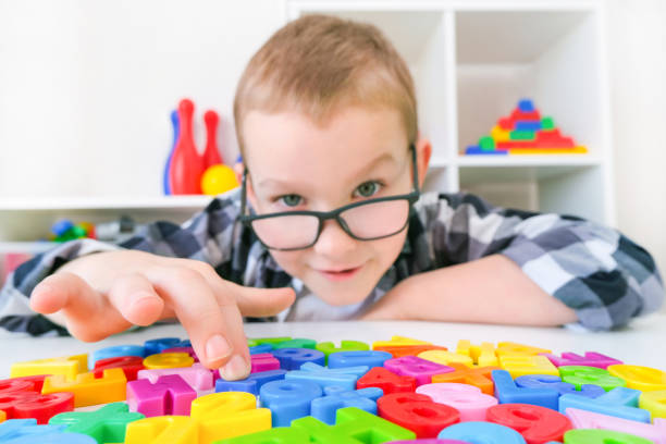 istock speech therapy. Toddler boy with letters. 1367100944