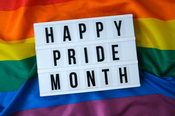 istock Rainbow flag with lightbox and text HAPPY PRIDE MONTH. Rainbow lgbtq flag made from silk material. Symbol of LGBTQ pride month. Equal rights. Peace and freedom 1367101501