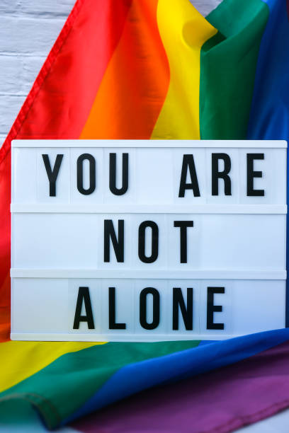 istock Rainbow flag with lightbox and text YOU ARE NOT ALONE. Rainbow lgbtq flag made from silk material. Symbol of LGBTQ pride month. Equal rights. Peace and freedom 1367101533