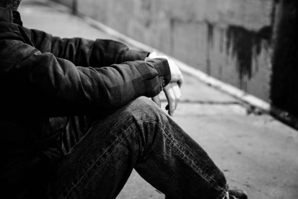 istock Homeless man sitting in cold dark subway tunnel 1367101928