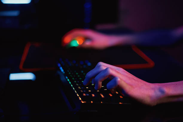 istock Gamer play computer game, use rgb neon colored keyboard 1367102876