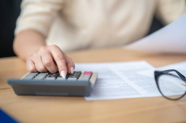 istock Bookkeeper calculating financial budget at the office desk 1367102976