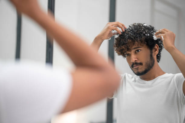 Male Rubbing The Hairstyling Product Into His Curls Stock Photo - Download  Image Now - iStock