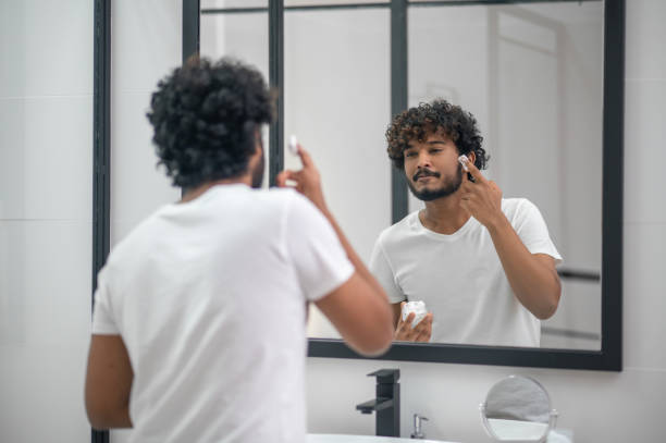 istock Focused man preparing for a shaving procedure 1367104182