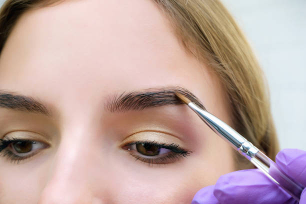 istock Young woman shaping eyebrows with brush 1367105102
