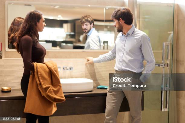 A Woman Visiting A Showroom And Choosing A New Sink Stock Photo - Download Image Now