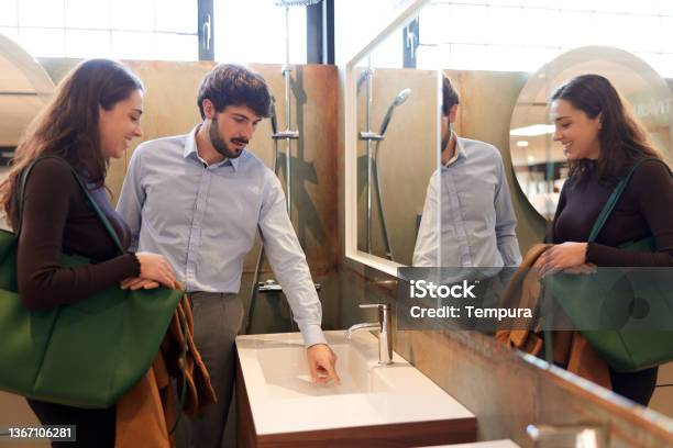 A Couple Is Buying Equipment For A New Bathroom Stock Photo - Download Image Now - Bathroom, Couple - Relationship, Renovation