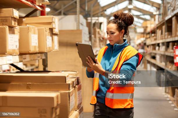 A Warehouse Worker Takes Inventory In The Storage Room Stock Photo - Download Image Now
