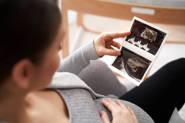 istock High angle view on caucasian woman in advanced pregnancy browsing ultrasound scan 1367107382