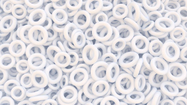 istock Abstract digital background with heap of white rubber rings 1367107479