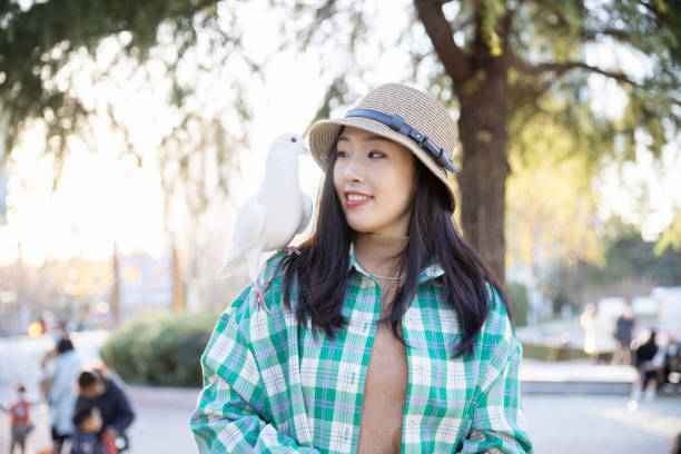 istock A pigeon standing on women shoulder 1367108924