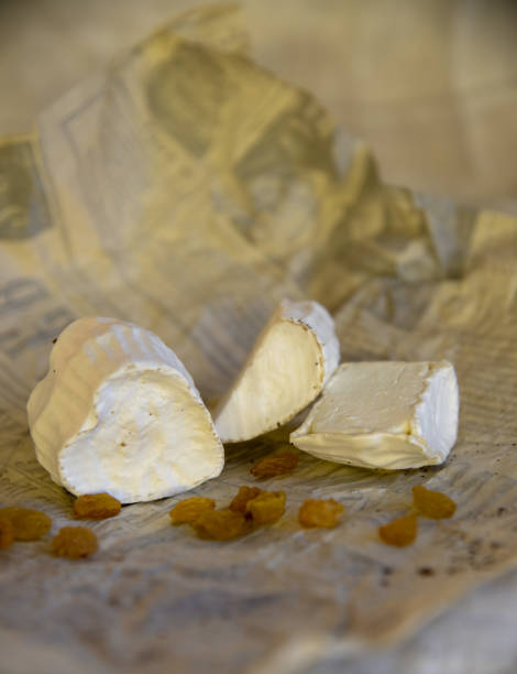 istock Various types of cheese with white mold on packaging paper. 1367109006