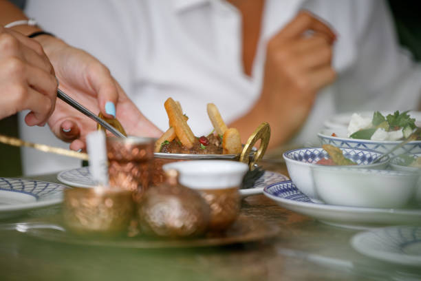 istock Holding spoon and taking specialty from copper bowl, dinner party at restaurant table 1367109128